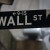 A Wall Street sign is pictured in the rain outside the New York Stock Exchange